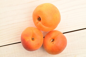Ripe sweet, organic apricots, close-up, on a painted wooden table