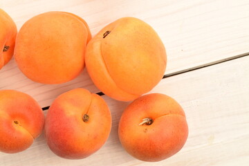 Ripe sweet, organic apricots, close-up, on a painted wooden table
