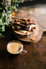 Obraz na płótnie Canvas chocolate bars on a Board with nuts