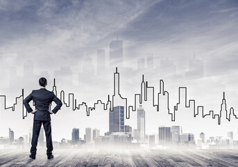 Motivation and inspiration concept with modern cityscape and businessman observing it