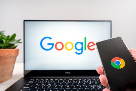 Google logo on dell laptop and on huawei p30 mobile phone device.