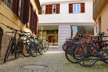 Fototapeta na wymiar many bicycles in an old town with cobblestone