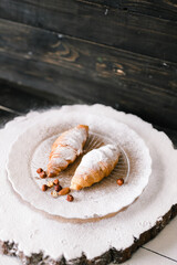 croissants sprinkled with icing on the plate