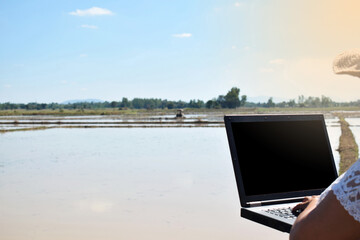 Farmers use computer on the farm. Selective focus. Concept for technology and agriculture.