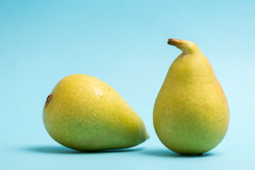 two ercoliana pears on blue background