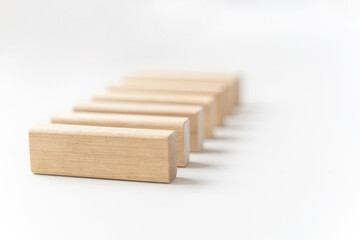 wooden bars lie on a light background. Selective focus