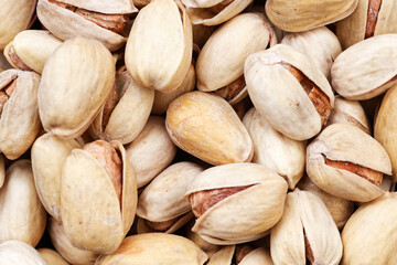 Closeup fried pistachio nuts with salt. Food background.