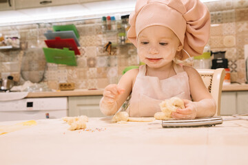 Little girl cooks at home in the kitchen