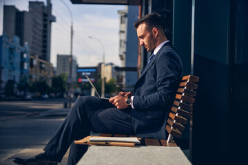 Concentrated brunette male working online alone outside