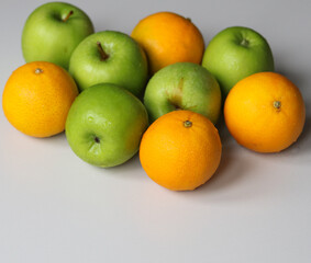 fresh tangerines and juicy green apples on a white background