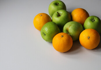 fresh tangerines and juicy green apples on a white background