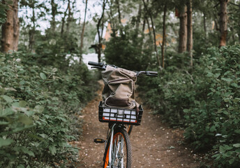 Fototapeta na wymiar bicycle with backpack on a forest path, active lifestyle, outdoor sports