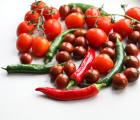 tomatoes and chili peppers  on a light background close up