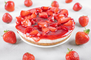 cheesecake with strawberry and fresh berries on gray table