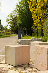 Granite cubes made for building. Geometric shape figures lying on the sidewalk.