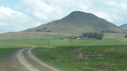 Scenic farmland in KZN, South Africa near Glencoe, in the summertime with a partly cloudy sky.