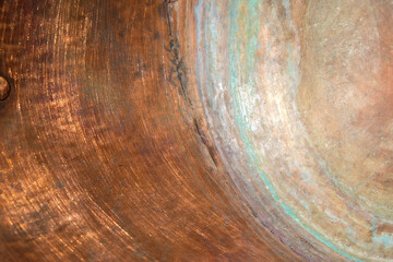 Copper surface of the inner wall of the copper pot. Green circles of copper oxidation. Copy space.
