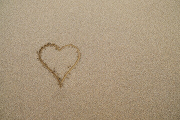 Heart drawing on the beach.