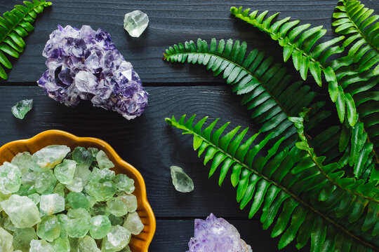 Amethyst Cluster with Bowl of Fluorite and Fern Leaves on Gray Background