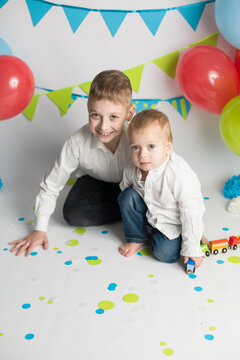 The brothers play with the train. the boy's birthday . decorations balloons and flags
