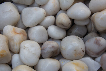 Fototapeta na wymiar White and gray stones used for decoration purpose. Smooth pebble stones used in water fountains