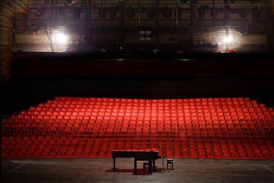 Empty concert hall or theater seats and piano on stage
