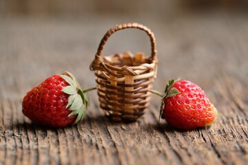  Colorful strawberries on the background of an old wooden table.