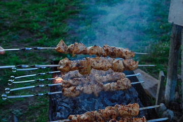 Fry kebabs mounted on skewers. Below are hot charcoals.