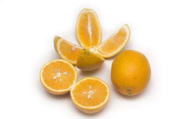 Orange fruit with orange slices and leaves isolated on white background.