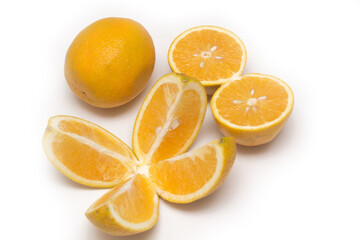 Orange fruit with orange slices and leaves isolated on white background.