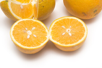 Orange fruit with orange slices and leaves isolated on white background.
