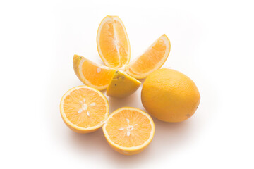 Orange fruit with orange slices and leaves isolated on white background.