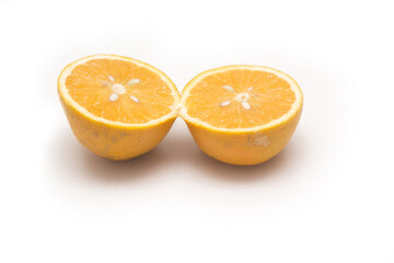 Orange fruit with orange slices and leaves isolated on white background.