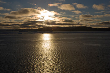 Fototapeta premium Antarctica landscape with ice and icebergs at sunset on a winter day