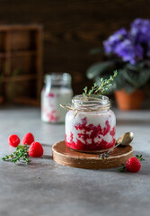 Raspberry smoothie, milkshake in a glass jar on a dark wooden background. Natural summer detox drink. Healthy eating concept.