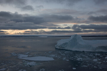 Antarctica landscape with ice and icebergs at sunset on a winter day