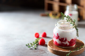 Raspberry smoothie, milkshake in a glass jar on a dark wooden background. Natural summer detox drink. Healthy eating concept.