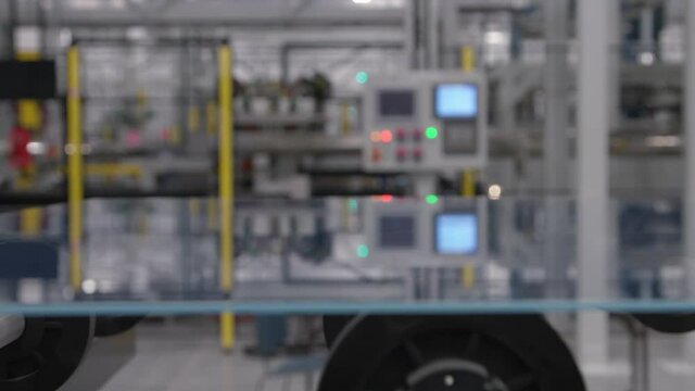 Large Glass Panels traveling on Conveyor Belt in Manufacturing Plant Facility