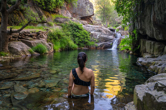 Woman in Drave waterfall cascata in Arouca Serra da Freita, Portugal