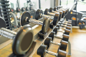 Obraz na płótnie Canvas Fitness club weight training equipment gym modern interior , Barbells of different weight on rack.