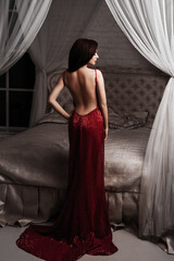 Fototapeta premium Fashion Model Red Dress, Elegant Woman in Sexy Evening Gown, Beautiful Girl Studio Shot on Black Background.Young beauty woman in fluttering red dress.Valentines Day border design.