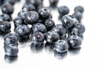 blueberries in water drops on a reflective background close up