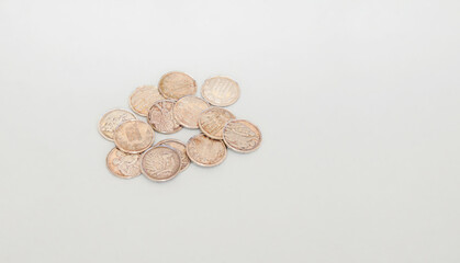 Arras, monedas para bodas. Monedas de plata y cobre con palabras religiosas en textura sobre fondo blanco textil.