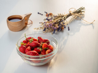 Still life of fresh strawberries tea and lavender