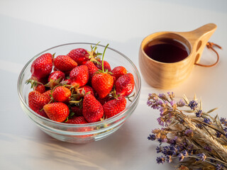 Still life of fresh strawberries tea and lavender