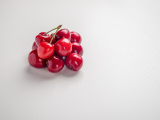 Sweet red cherries on white