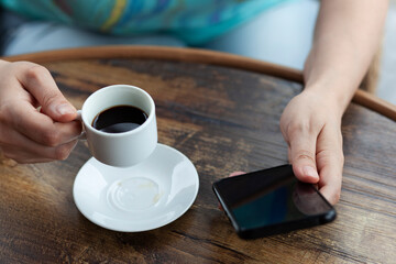  woman hand phone with coffee