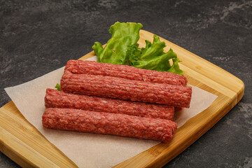 Raw beef sausages with spices