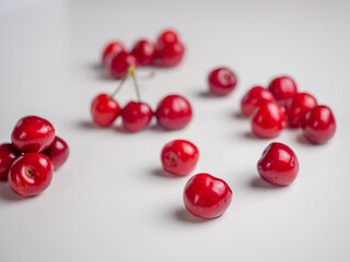 Naklejka na ściany i meble Sweet red cherries on white