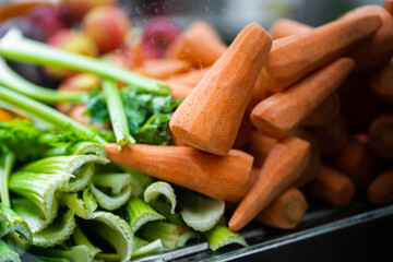 Juice Bar with assorted fresh fruits and vegetables. Tropical summer outdoor background.Various vegetables on the counter. organic fresh fruits and vegetables on grocery counter.Detoxification concept